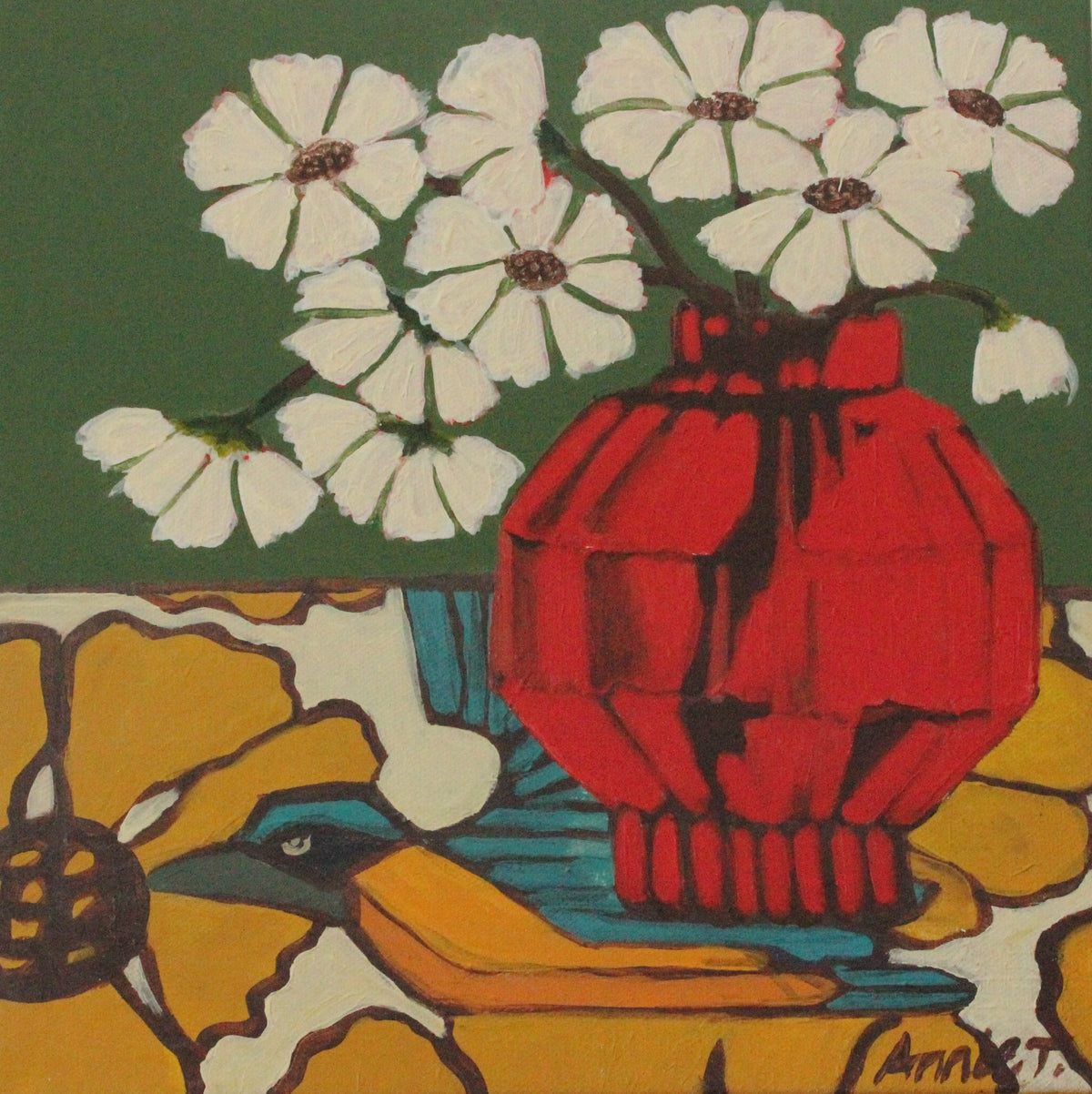 A square canvas painting featuring a stylized still life with white flowers, a red vase, yellow flowers, and a blue bird on a green and yellow background, leaning against a white paneled wall on a wooden surface.